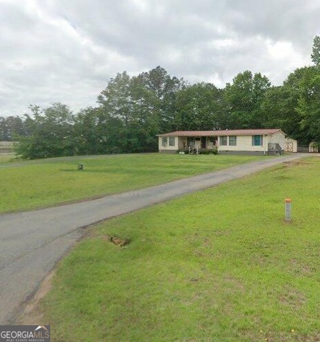 a front view of a house with a big yard