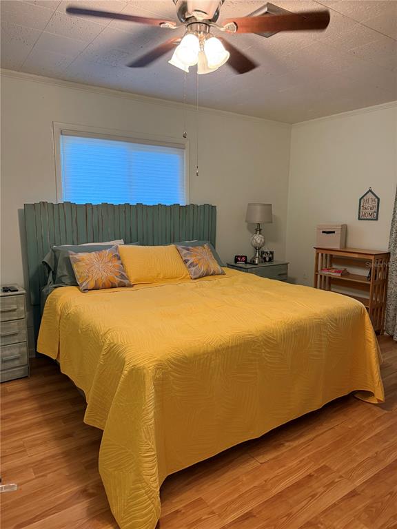 421 Riviera Street Venice, FL 34285 - Photo 11 of 31 a bedroom with a bed and wooden floor