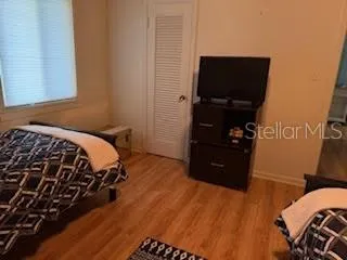 a bedroom with a bed and a television