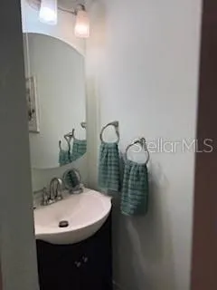 a bathroom with a sink and mirror