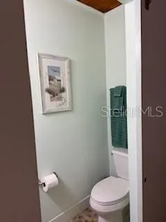 a white toilet sitting next to a bathroom sink