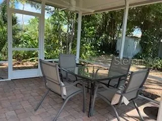 a view of an outdoor sitting area with furniture and backyard