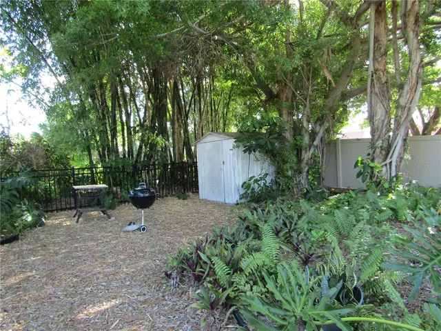 a view of a chair and table in the garden