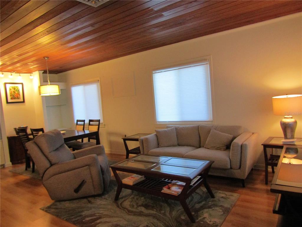 421 Riviera Street Venice, FL 34285 - Photo 3 of 31 a living room with furniture a rug and a chandelier