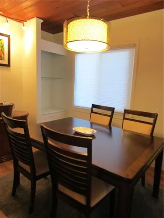 a view of a dining room with furniture and a window