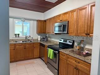 421 Riviera Street Venice, FL 34285 - Photo 8 of 31 a kitchen with stainless steel appliances granite countertop wooden cabinets a stove top oven a sink and dishwasher