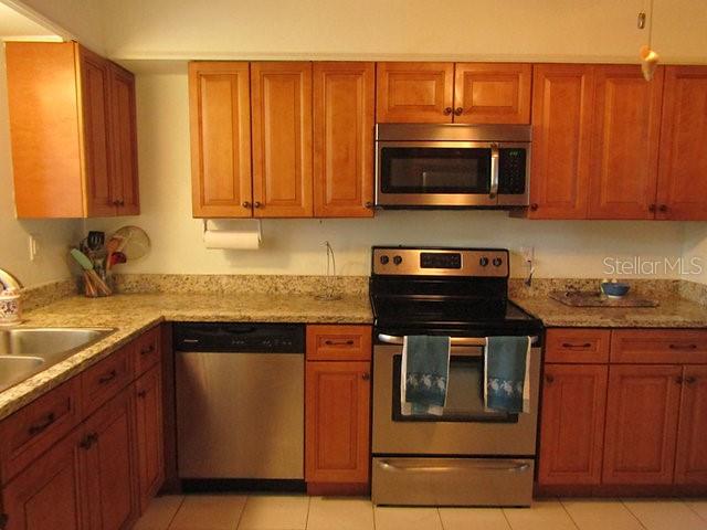 421 Riviera Street Venice, FL 34285 - Photo 10 of 31 a kitchen with stainless steel appliances granite countertop a stove microwave and sink