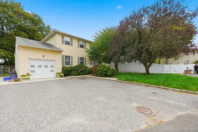 a front view of a house with a yard and a garage