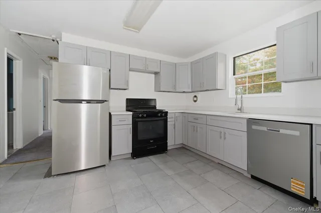 a kitchen with white cabinets and white appliances