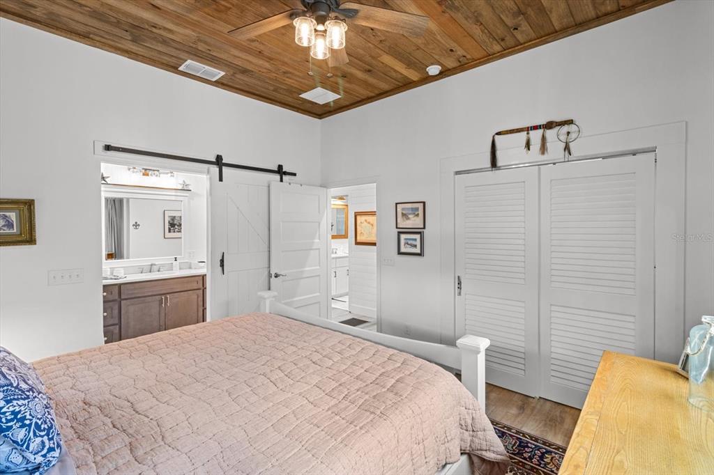 5328 Riverside Drive Yankeetown, FL 34498 - Photo 18 of 46 a bedroom with a bed and a chandelier