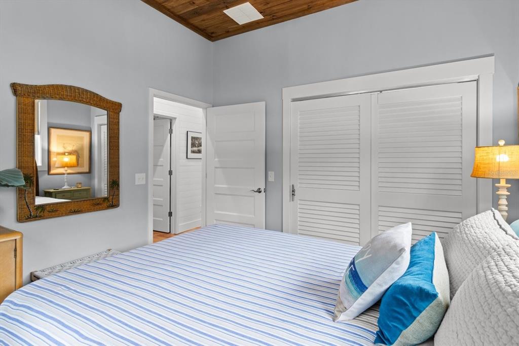 5328 Riverside Drive Yankeetown, FL 34498 - Photo 23 of 46 a bedroom with a bed and a lamp on table