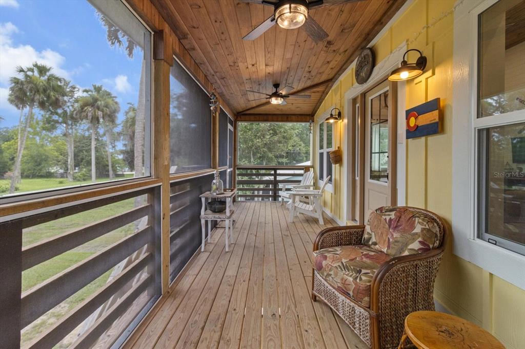 5328 Riverside Drive Yankeetown, FL 34498 - Photo 3 of 46 a view of a balcony with chairs and wooden floor