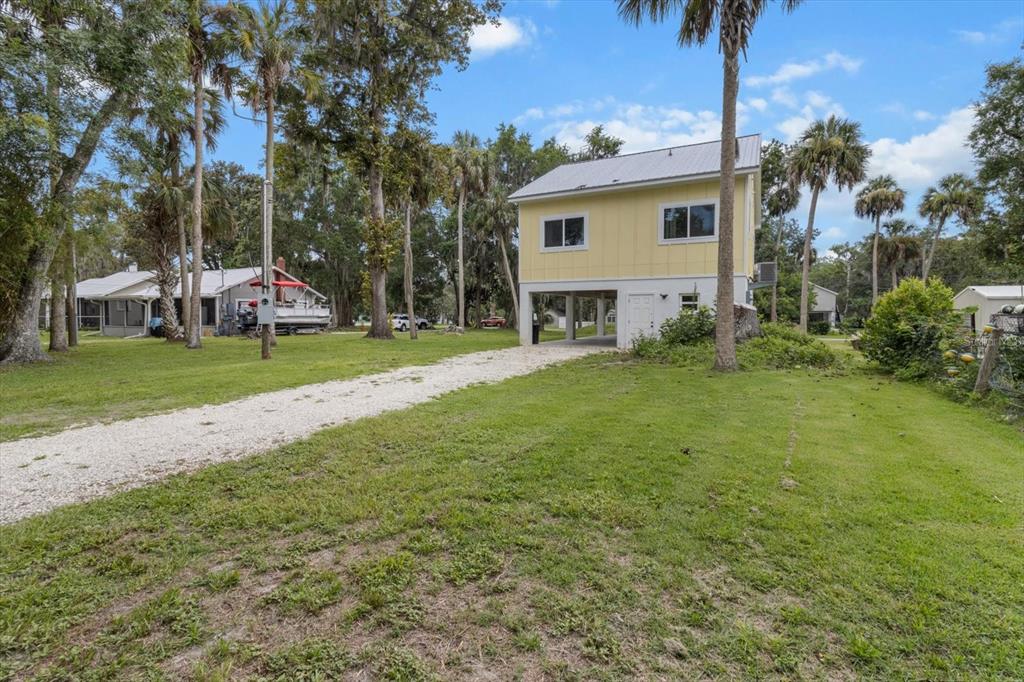 5328 Riverside Drive Yankeetown, FL 34498 - Photo 37 of 46 a view of a house with a big yard and large trees