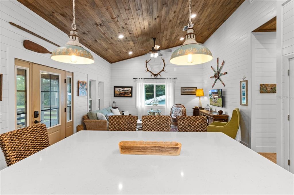 5328 Riverside Drive Yankeetown, FL 34498 - Photo 7 of 46 a bedroom with a bed a chandelier and couch