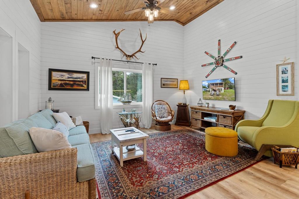 5328 Riverside Drive Yankeetown, FL 34498 - Photo 9 of 46 a living room with furniture a rug and a chandelier