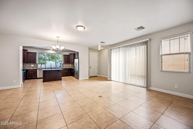 a view of a kitchen with a sink and a large window in a room