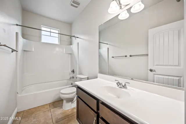 a bathroom with a double vanity sink mirror and toilet