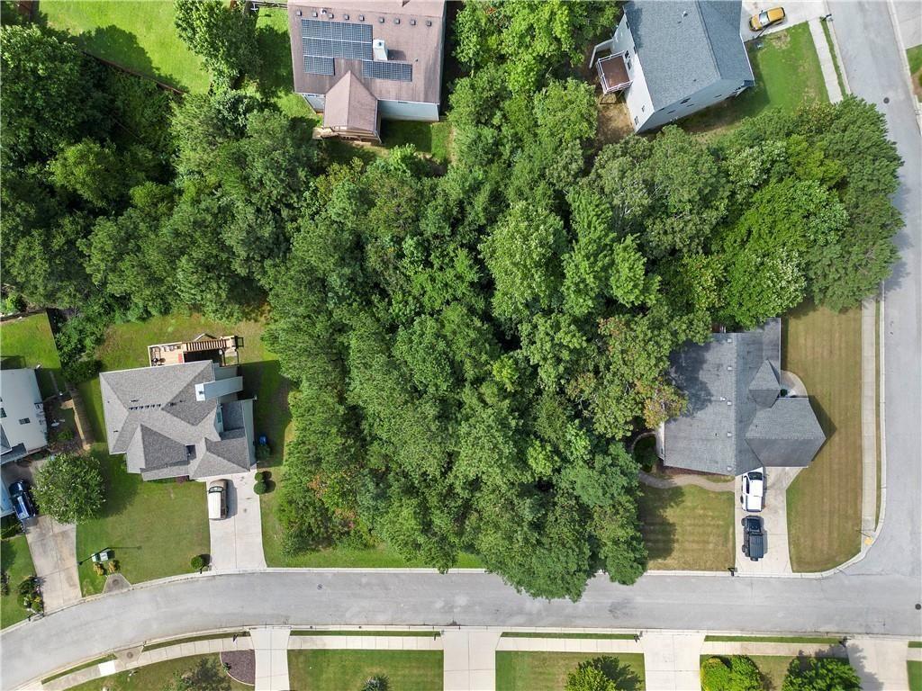 an aerial view of a house with garden space and street view