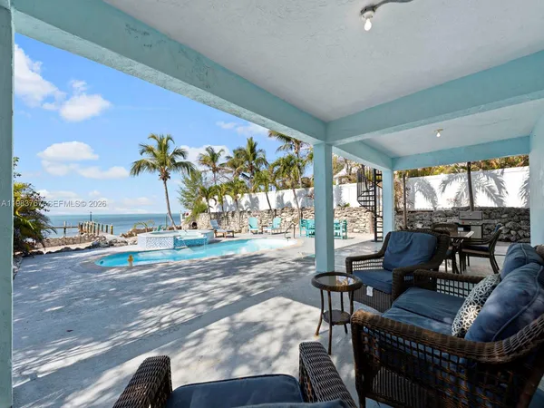 a view of a swimming pool with an outdoor seating