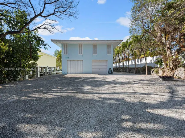 a front view of a house with garden and porch