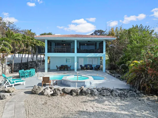 a front view of house with outdoor seating