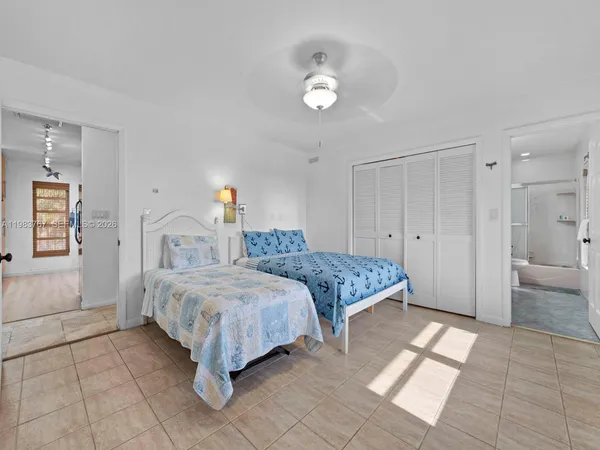 a bedroom with a bed a couch and a flat screen tv