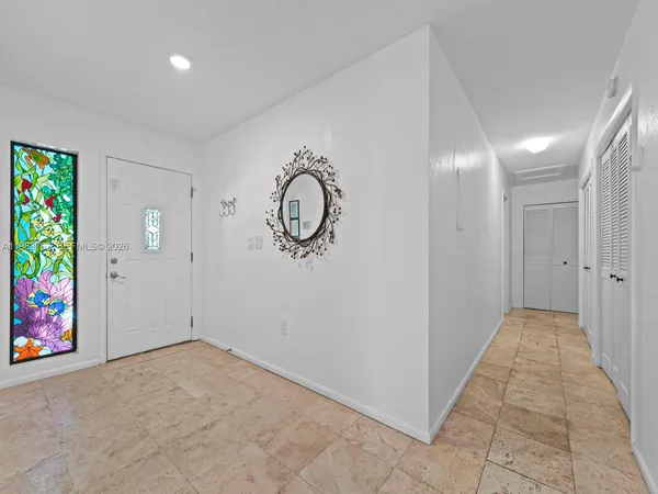 a bathroom with a sink a toilet a mirror and shower