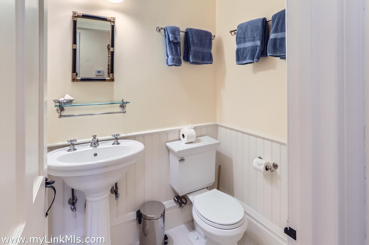 27 Spring Street Vineyard Haven, MA 02568 - Photo 49 of 58 a bathroom with a toilet sink and mirror