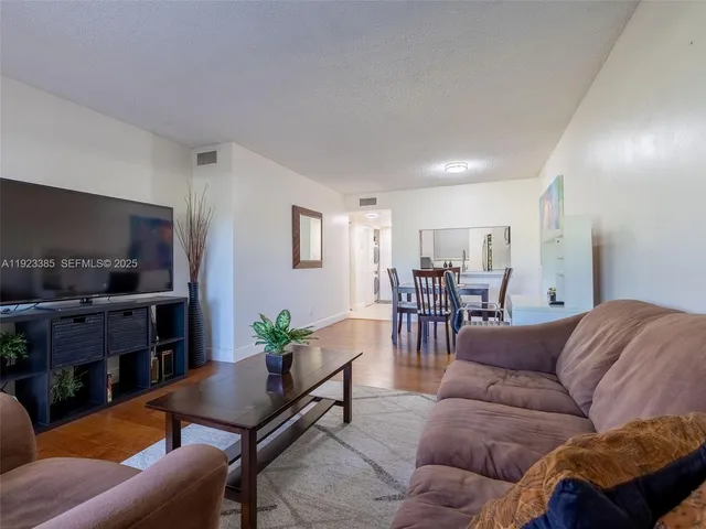 a living room with furniture a dining table and a fireplace