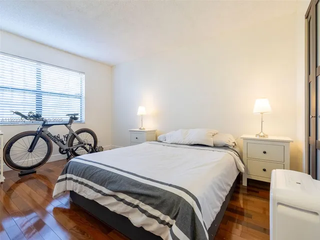 a bedroom with a bed and a table with chair