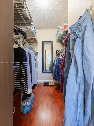 a view of walk in closet with clothes