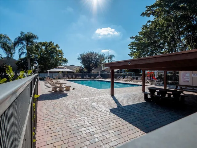 a view of a patio with a table and chairs