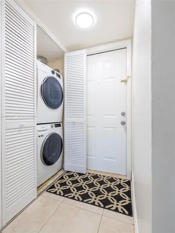a utility room with sink dryer and washer