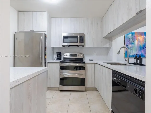 a kitchen with stainless steel appliances a refrigerator sink and microwave