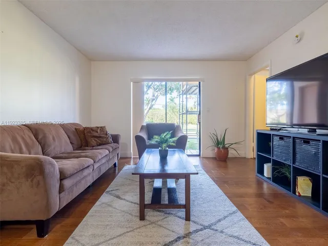 a living room with furniture a dining table with wooden floor