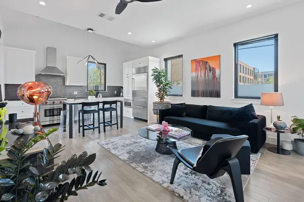 a living room with furniture and wooden floor