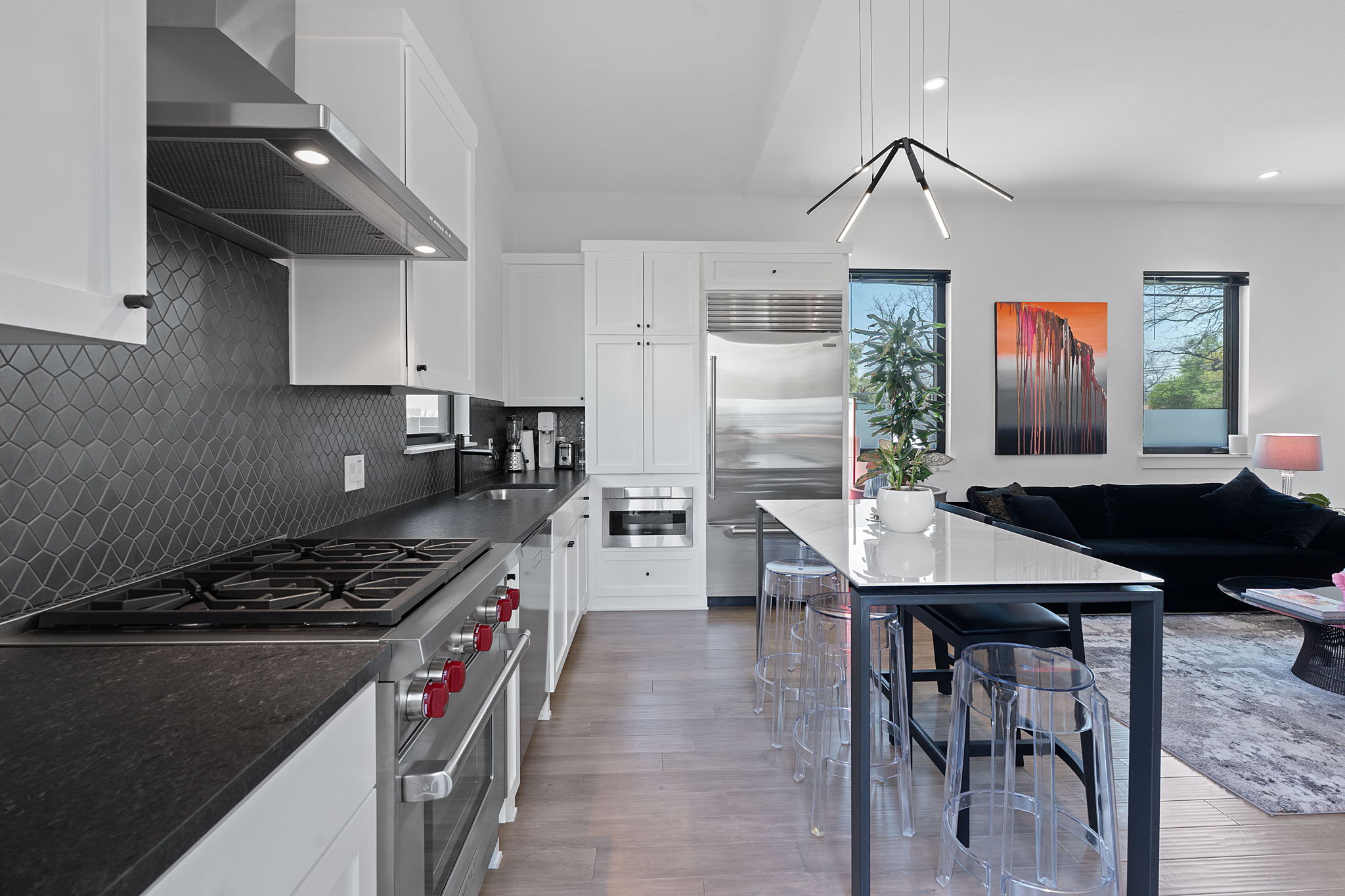 308 Onion Street Austin, TX 78702 - Photo 12 of 40 a kitchen with stainless steel appliances granite countertop a stove a sink dishwasher a dining table and chairs with wooden floor
