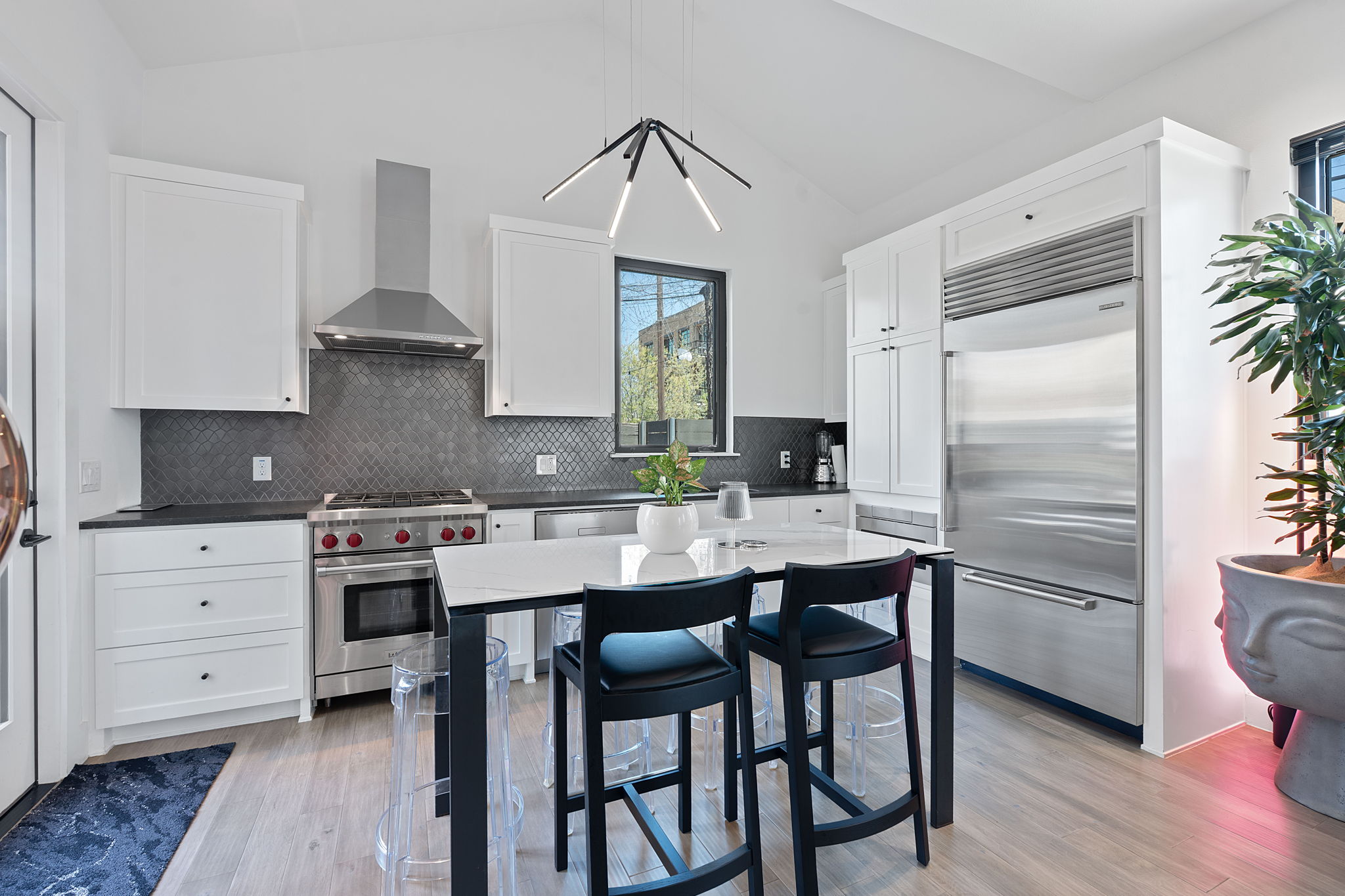 308 Onion Street Austin, TX 78702 - Photo 8 of 40 a kitchen with a table chairs refrigerator and cabinets