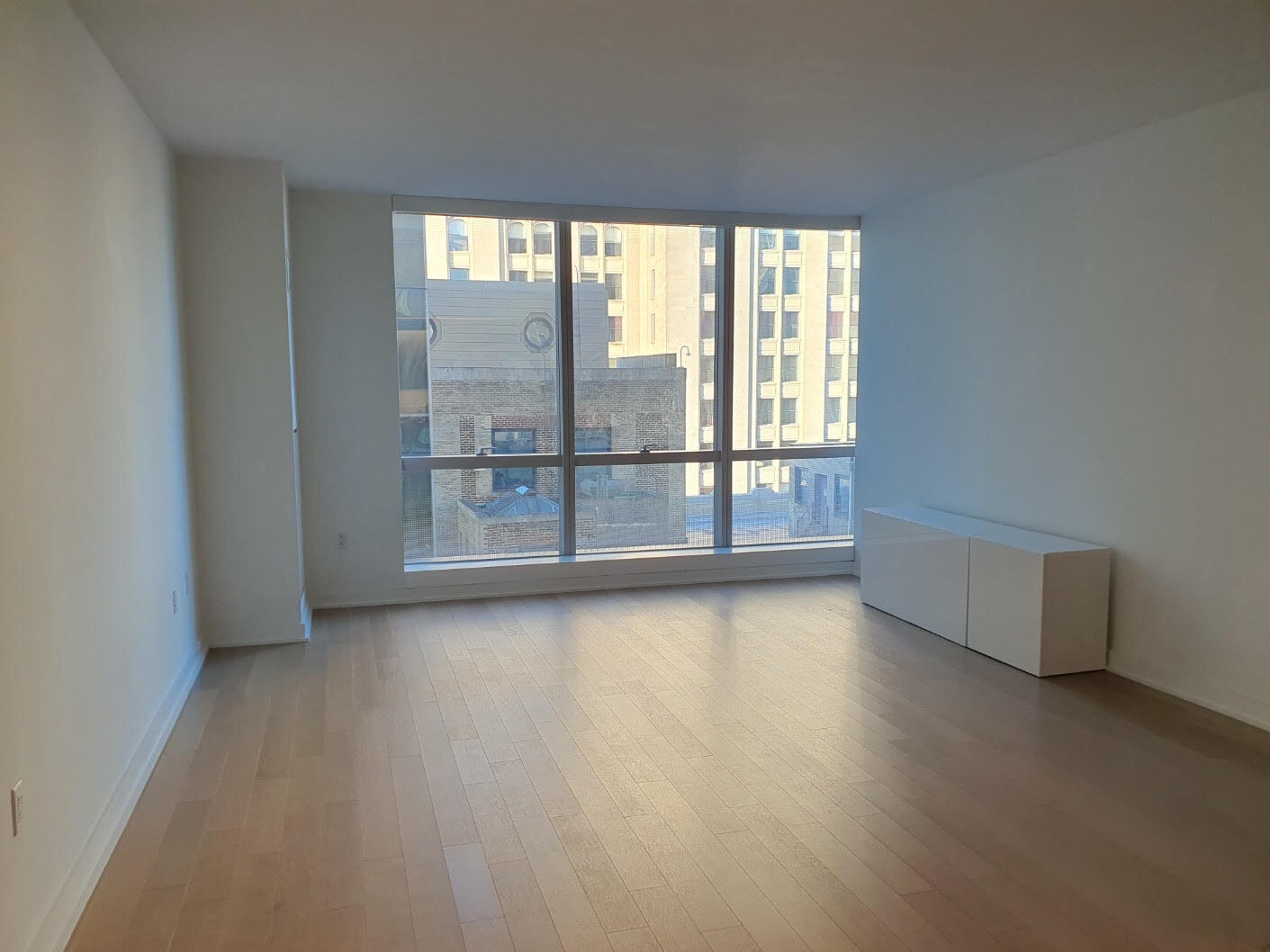 400 Park Avenue South, Unit 25G Manhattan, NY 10016 - Photo 1 of 12 an empty room with wooden floor and windows