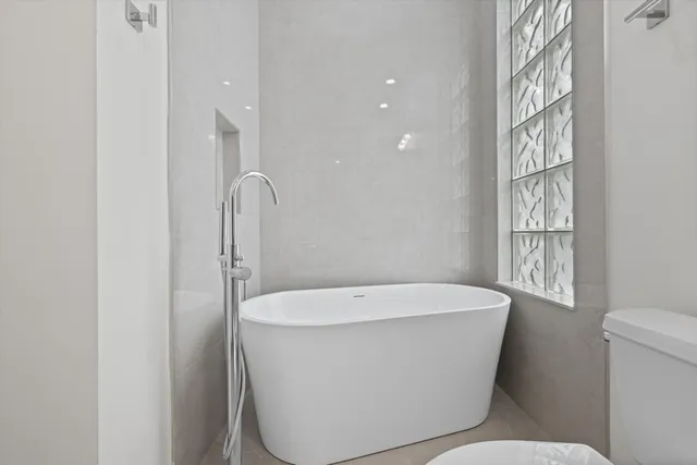 a white bath tub sitting next to a white toilet