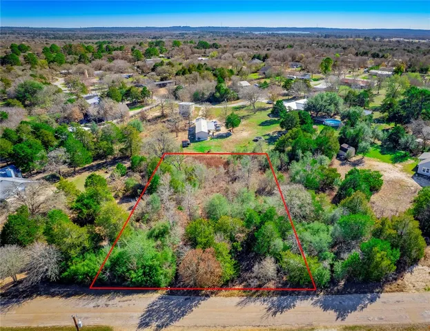 an aerial view of a forest with houses