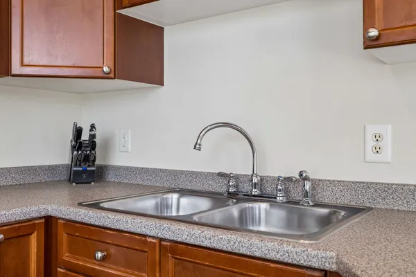 a kitchen with granite countertop a sink and cabinets