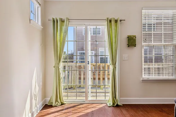 a view of a balcony with wooden floor and fence