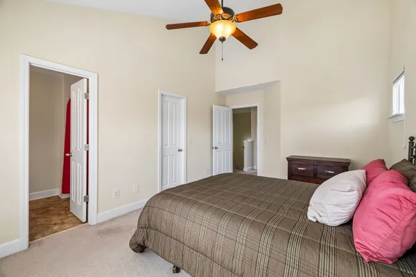 a bedroom with a bed and a lamp