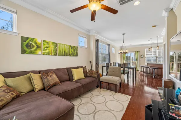 a living room with furniture and wooden floor