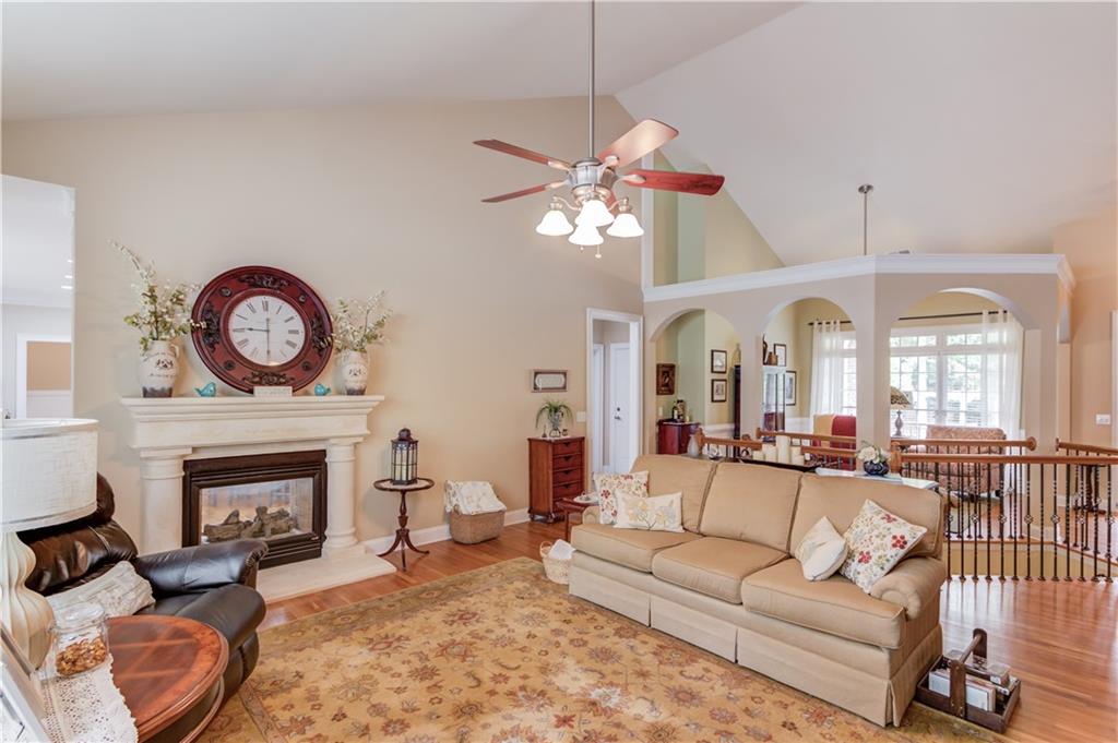 901 Providence Lane Monroe, GA 30656 - Photo 18 of 76 a living room with furniture a fireplace and a large mirror