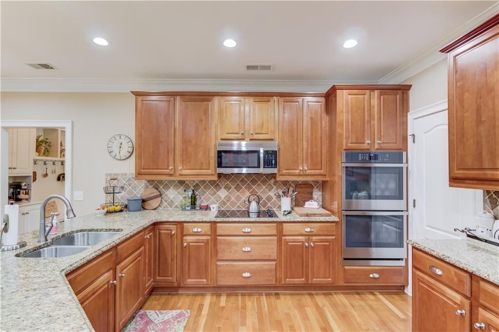 901 Providence Lane Monroe, GA 30656 - Photo 20 of 76 a kitchen with a sink stove and cabinets