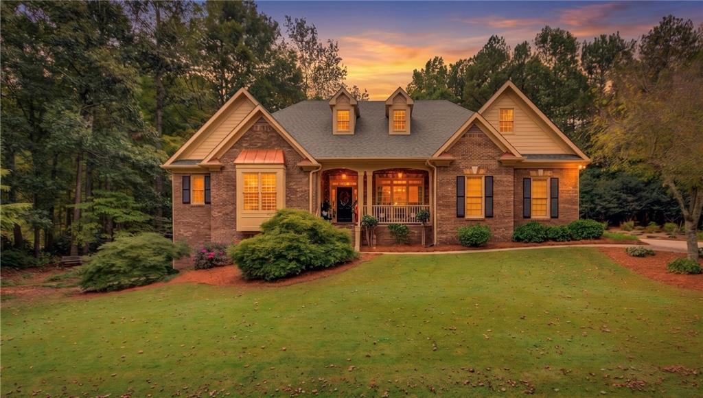 901 Providence Lane Monroe, GA 30656 - Photo 2 of 76 a front view of a house with a yard and garage
