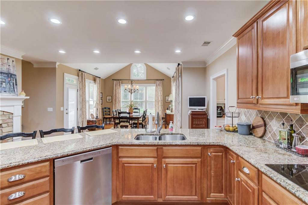 901 Providence Lane Monroe, GA 30656 - Photo 21 of 76 a kitchen with lots of counter top space sink and living room