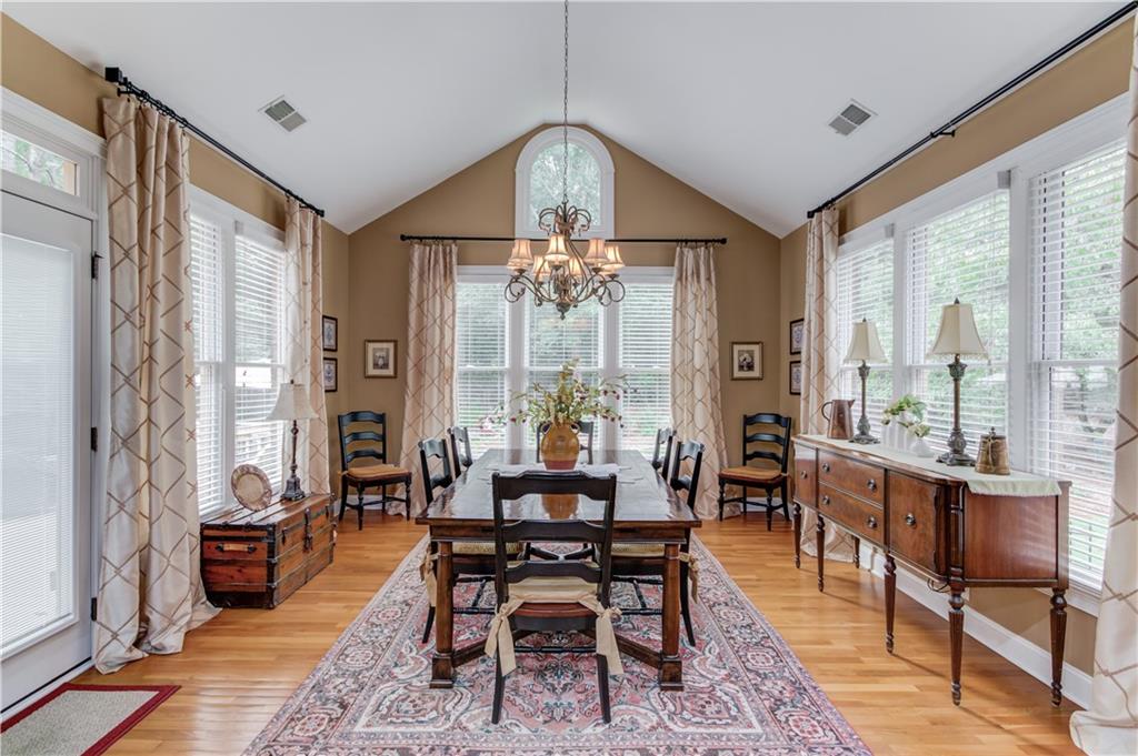 901 Providence Lane Monroe, GA 30656 - Photo 23 of 76 a dining room with furniture a chandelier and wooden floor